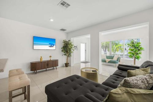 a living room with a couch and a table at Modern 4BR Retreat with Private Pool - Near Brickell in Miami