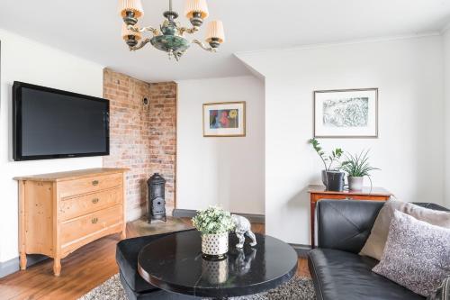 a living room with a couch and a table at Linden 1 in Gullberg
