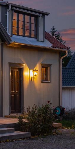 a house with a light on the side of it at Linden 1 in Gullberg