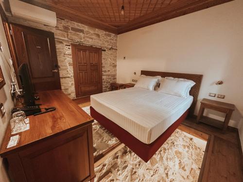 a bedroom with a bed and a television in it at Kalemi Twin Boutique Hotel in Gjirokastër