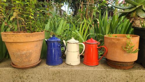 a group of different colored vases sitting on a ledge at Le N 9 in Argeliers
