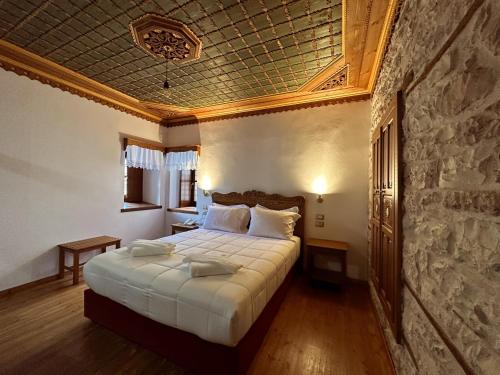 a bedroom with a large bed in a room at Kalemi Twin Boutique Hotel in Gjirokastër