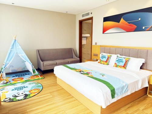 a bedroom with a bed with a tent and a chair at Ibis Styles Gu'an Daxing Airport Wildlife Park Hotel in Gu'an