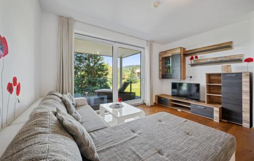 a living room with a couch and a tv at Ferienwohnung Pörtschach 90M² in Pörtschach am Wörthersee