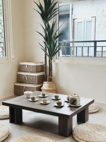 - une table basse dans le salon avec une plante dans l'établissement B House - 3Br 2Bath Balcony 5ms Lake Quiet Old Quater, à Hanoï