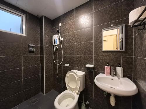 a bathroom with a toilet and a sink at Simfoni Comfy Premium 12 in Langkawi Islands