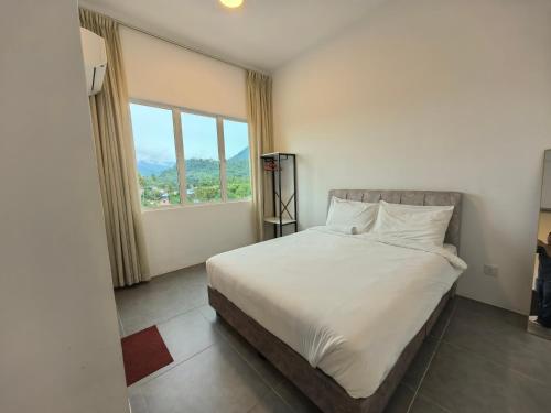 a bedroom with a bed and a large window at Simfoni Comfy Premium 12 in Langkawi Islands