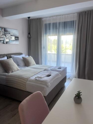 a bedroom with a large bed and a window at Vrnjačko Vrelo Resort in Novo Selo
