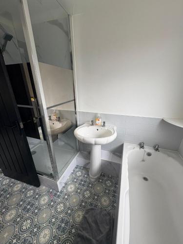 a bathroom with a sink and a toilet and a tub at Refurbished 4-Bed Home Near Hospital & Station in Chatham