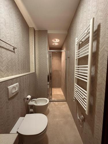 a bathroom with a toilet and a sink at Kalemi Twin Boutique Hotel in Gjirokastër