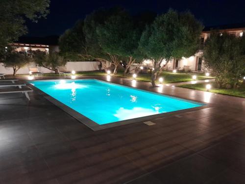 a swimming pool at night with lights at Resort La Ficaccia in La Marmorata