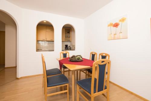 a kitchen and dining room with a table and chairs at Appartements Huber in Fügen