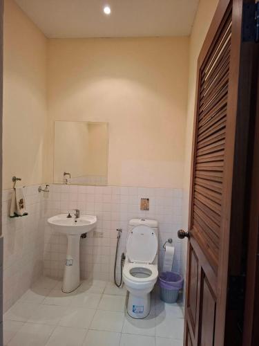 a bathroom with a toilet and a sink at Exclusive 10-Person Villa with Pool & land 6000m in Ban Hui Yai Muk