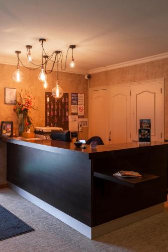 a large kitchen with a large black counter top at Logis Hotel-Restaurant Saint Romain in Anse