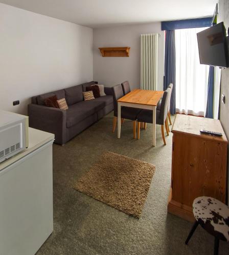 a living room with a couch and a table at Shackleton Chalet in Sestriere