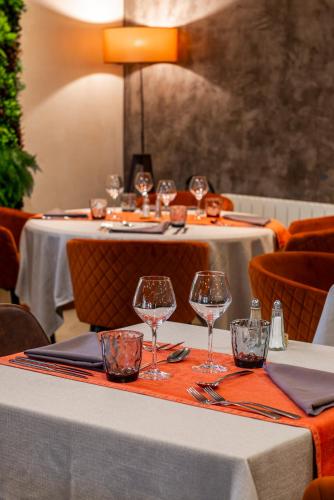 a table with wine glasses on top of it at Logis Hotel-Restaurant Saint Romain in Anse