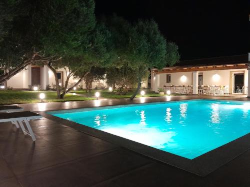 a swimming pool in front of a house at night at Resort La Ficaccia in La Marmorata