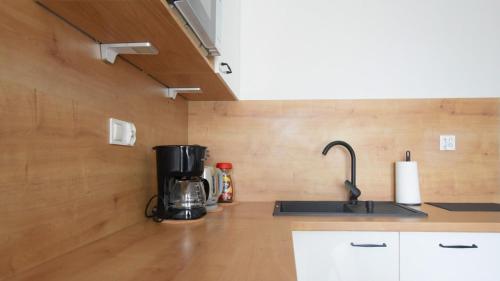a kitchen with a coffee maker on a counter at VacationClub - Lotnicza 1L Apartament 44 in Sianozety