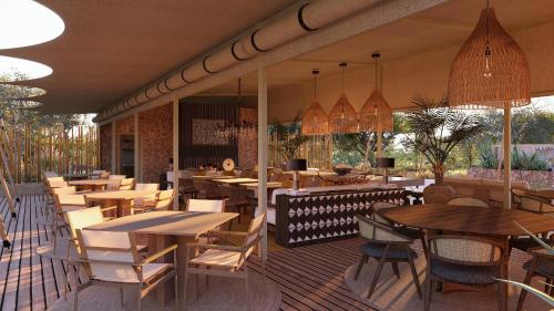 a restaurant with tables and chairs on a deck at Mapito Safari Camp, Serengeti, Autograph Collection in Serengeti