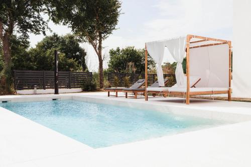 a swimming pool with a gazebo and a swing at Villa Vicenta in Svetvinčenat