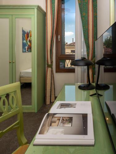 a room with a table with a book on it at Hotel Donatello in Padova