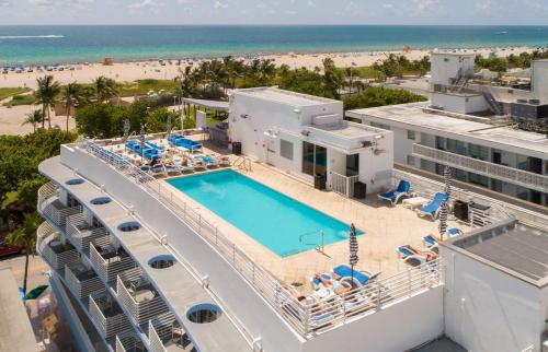 an aerial view of a resort with a swimming pool and the beach at Heart of Ocean Drive - Studio - Rooftop Pool in Miami Beach