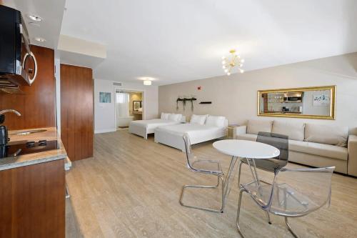 a living room with a bed and a table and chairs at Heart of Ocean Drive - Studio - Rooftop Pool in Miami Beach