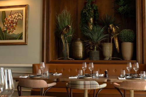 a dining room with a table with glasses and plants at Crieff Hydro Self Catering in Crieff