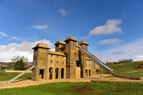 a small building with a slide in a field at Crieff Hydro Self Catering in Crieff