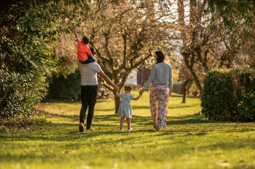 two adults and a child walking in a park at Crieff Hydro Self Catering in Crieff