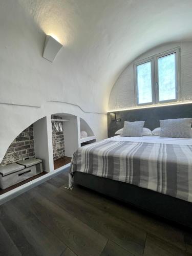 a bedroom with a large bed and a fireplace at Calliope in Gallipoli