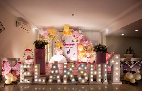a birthday party with a sign that says baby baptized at Hotel Shubham Grand in Bhubaneshwar