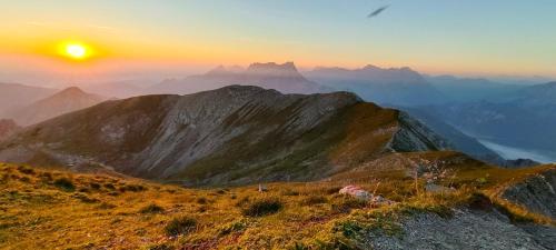 a sunset on the top of a mountain at Privatzimmer und Ferienwohnungen Gassner in Admont