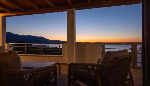 a room with two chairs and a view of the sunset at Kallidimi's House in Monemvasia