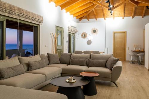 a living room with a couch and a table at Kallidimi's House in Monemvasia