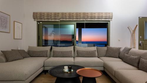 a living room with a couch and a table at Kallidimi's House in Monemvasia