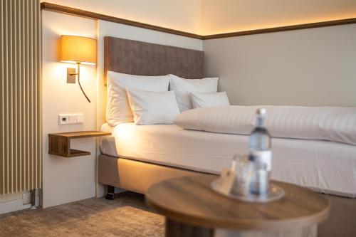 a hotel room with a bed and a table at Dorint Strandresort & Spa Ostseebad Wustrow in Wustrow