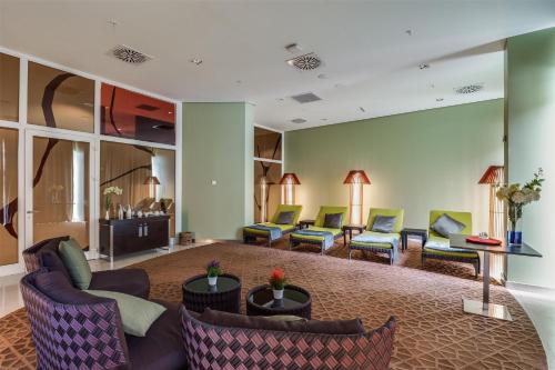 a waiting room with couches and tables and chairs at Radisson Blu Hotel & Convention Centre Kigali in Kigali