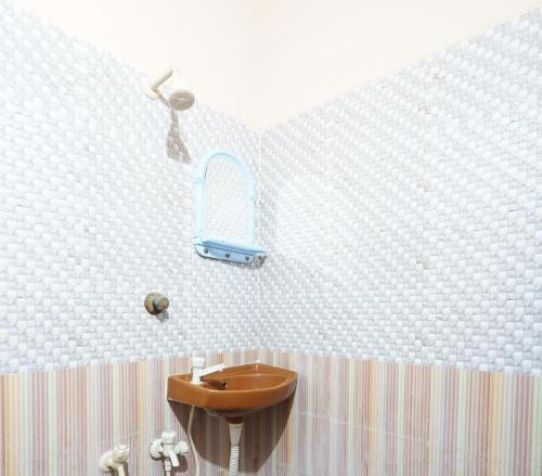 a bathroom with a sink and a mirror on the wall at Royal Park in Vellore