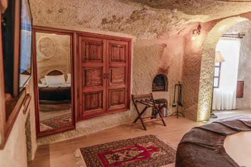 a bedroom with a large mirror and a bed at Utopia Cave Cappadocia in Urgup