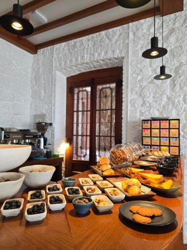 a table with many different types of food on it at Hotel Quinta Solera in Oviedo
