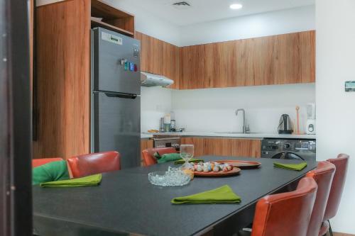a kitchen with a table with a plate of food on it at Oasis 2 Masdar City in Abu Dhabi