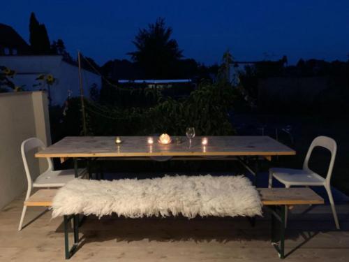 a picnic table with a white rug on a patio at Charmantes Ferienhaus Wolf Schaefer in Gelbensande