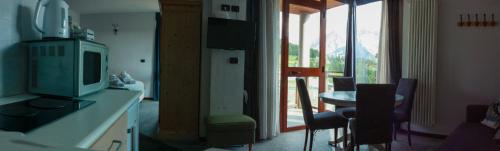 a kitchen with a table and chairs and a window at Shackleton Chalet in Sestriere