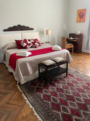 a bedroom with a large bed with a red blanket at B&B Del Vescovado in Reggio Emilia