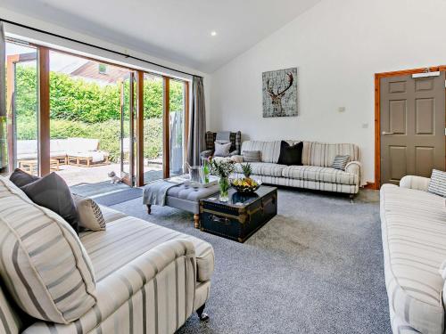 a living room with two couches and a table at 6 bed in Buckland Brewer 75553 in Buckland Brewer