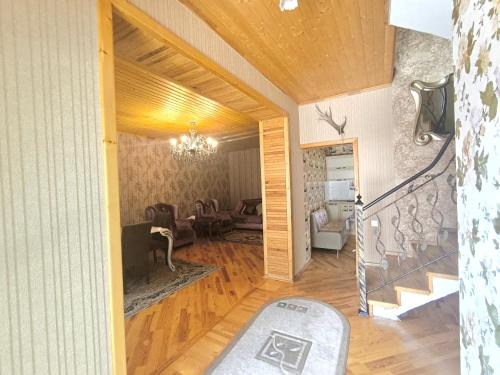 a living room with a stairway and a living room with at İsmayıllı dağın ətəyində kirayə ev in İsmayıllı