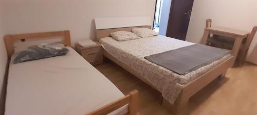 two beds in a small room with at Airport Nikki Apartments in Belgrade