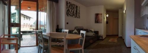 a kitchen and living room with a table and chairs at Shackleton Chalet in Sestriere