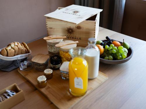 a table with a basket of fruit and a box of milk at Tenute Maestrale Wine Lodge in Donori